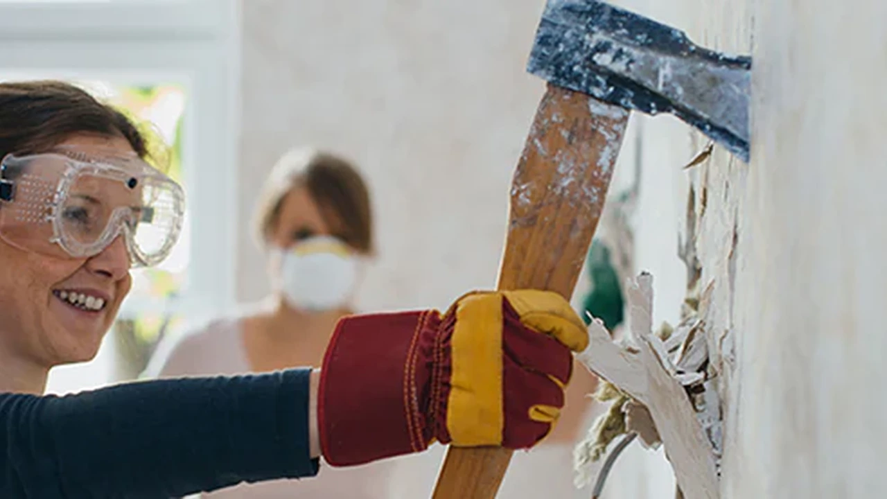 Close up on a plate of mashed potatoes, topped with baked pork chops with cream of mushroom soup, and a side of green beans.