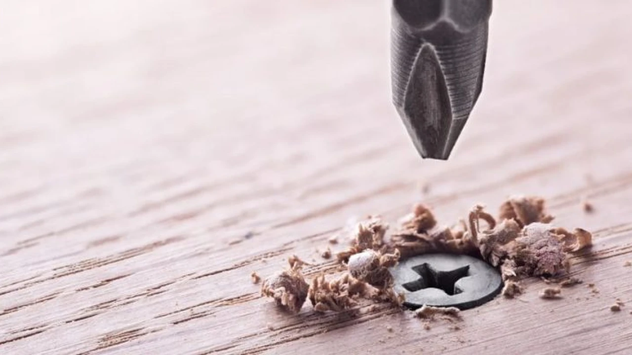 Close up on a plate of mashed potatoes, topped with baked pork chops with cream of mushroom soup, and a side of green beans.