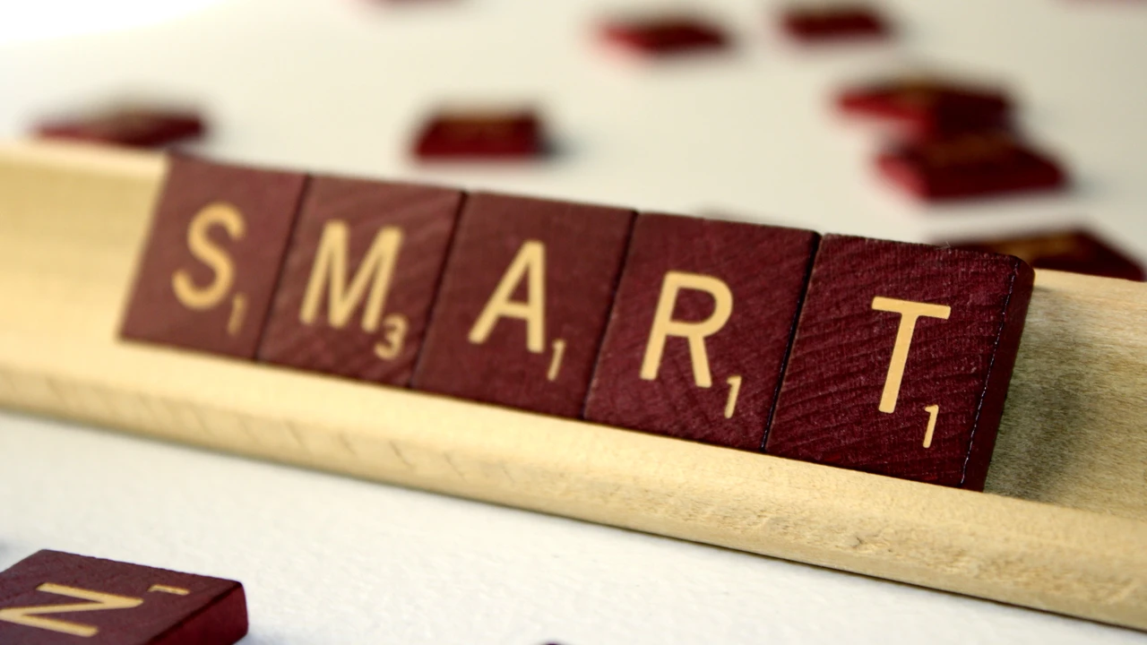 Close up on a plate of mashed potatoes, topped with baked pork chops with cream of mushroom soup, and a side of green beans.